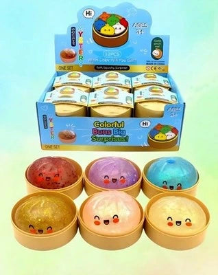 Colorful toy bowls with smiling faces in a display box on a gradient background